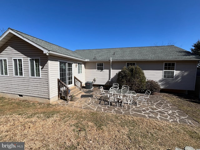 back of house featuring roof with shingles, a patio, a lawn, central AC unit, and entry steps