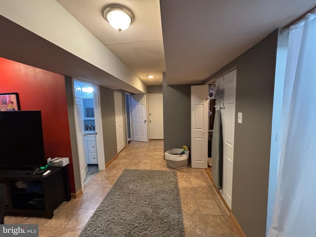 corridor featuring baseboards