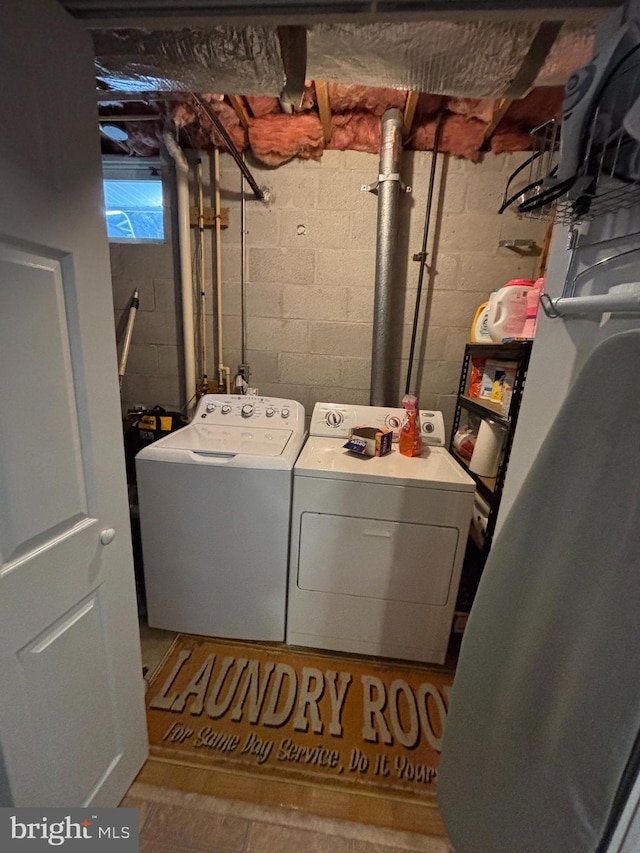 clothes washing area featuring laundry area and washing machine and clothes dryer