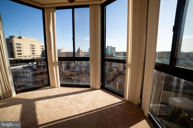 sunroom / solarium featuring a city view