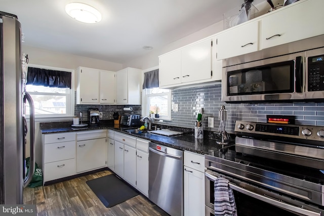 kitchen with a wealth of natural light, stainless steel appliances, and backsplash