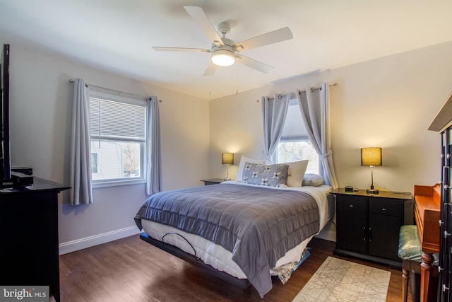 bedroom featuring a ceiling fan, baseboards, and wood finished floors