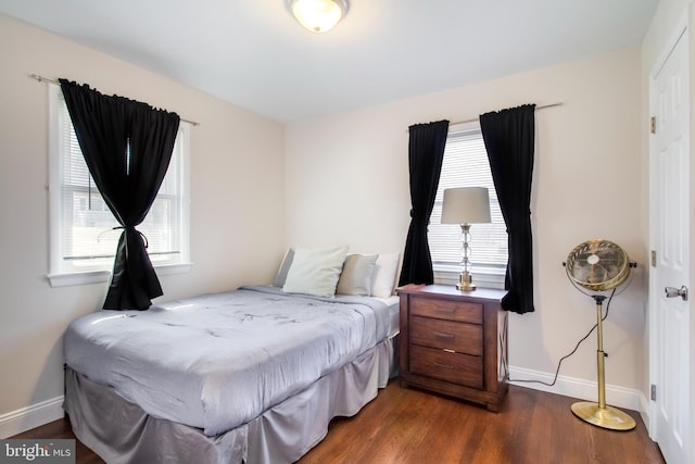 bedroom with baseboards and wood finished floors