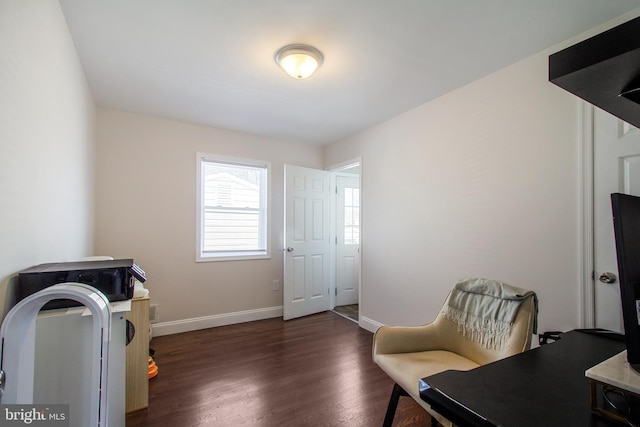 living area featuring dark wood-style floors and baseboards