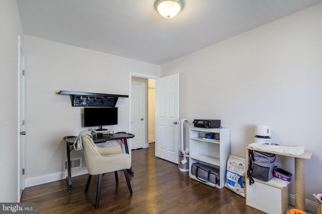 office space with wood finished floors, visible vents, and baseboards