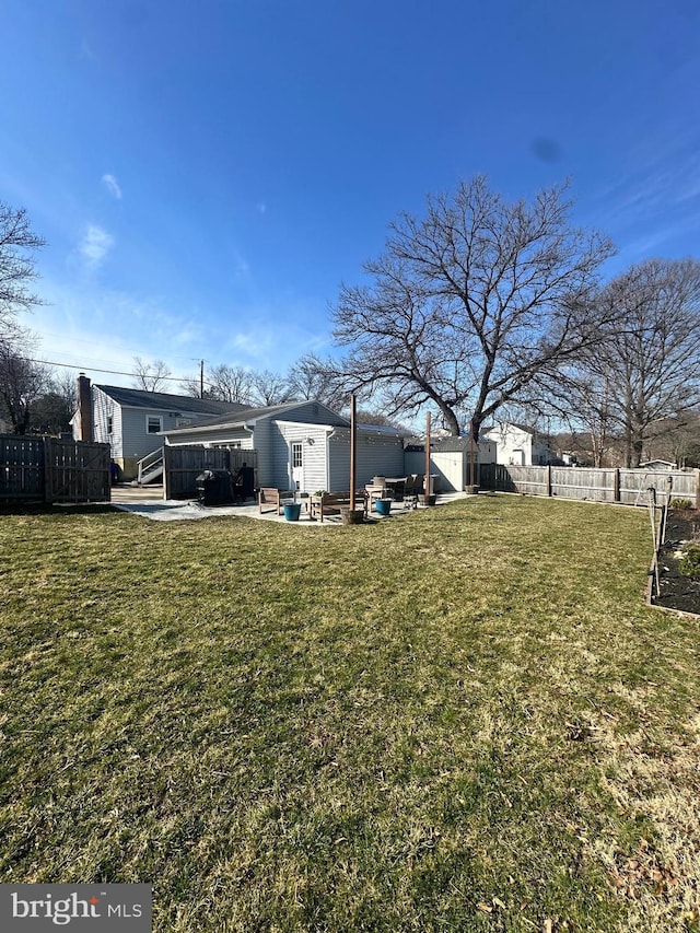 view of yard featuring a patio and a fenced backyard