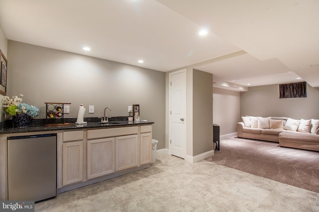 bar featuring indoor wet bar, recessed lighting, freestanding refrigerator, and a sink