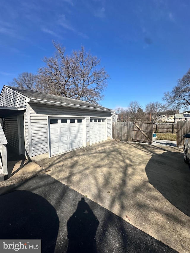 detached garage featuring fence