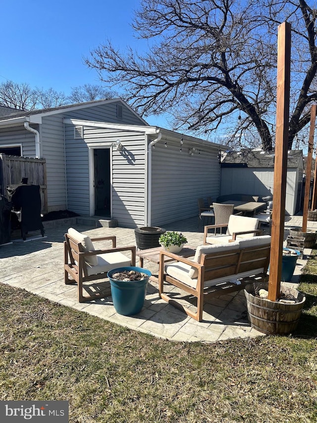 view of patio featuring outdoor lounge area and fence