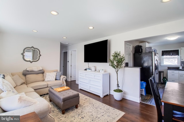 living room featuring dark wood finished floors, recessed lighting, and baseboards