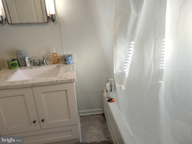 full bathroom with tile patterned floors, curtained shower, a washtub, and vanity