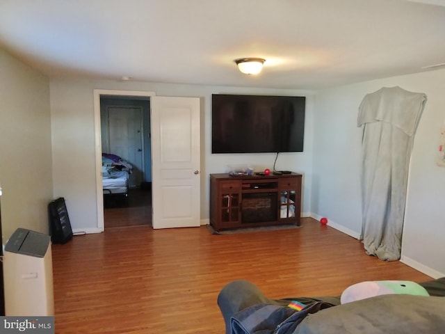 living area with wood finished floors and baseboards