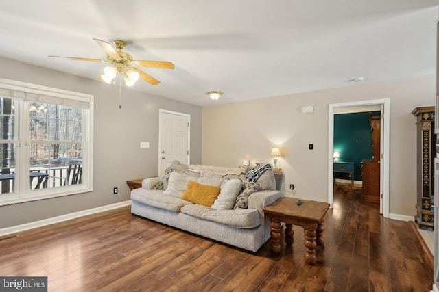 living room featuring ceiling fan, wood finished floors, visible vents, and baseboards