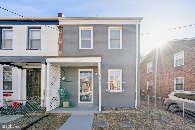 multi unit property with brick siding and fence