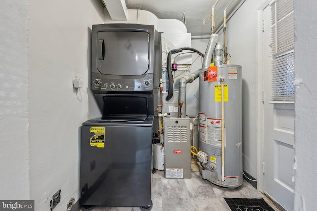 utility room featuring stacked washer and clothes dryer and water heater