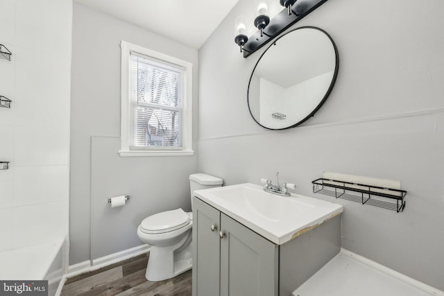 full bathroom with vanity, wood finished floors, baseboards, a shower, and toilet