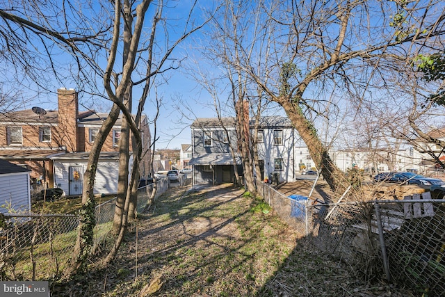 view of yard featuring a residential view and a fenced backyard