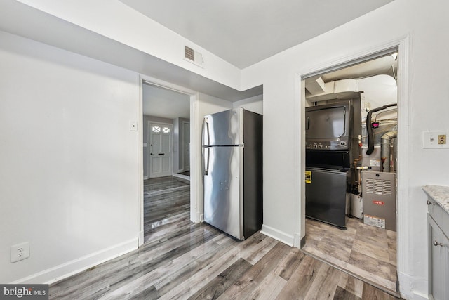 interior space with baseboards, visible vents, and light wood finished floors