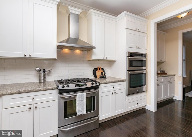 kitchen with backsplash, crown molding, wall chimney range hood, stainless steel appliances, and dark wood-style flooring