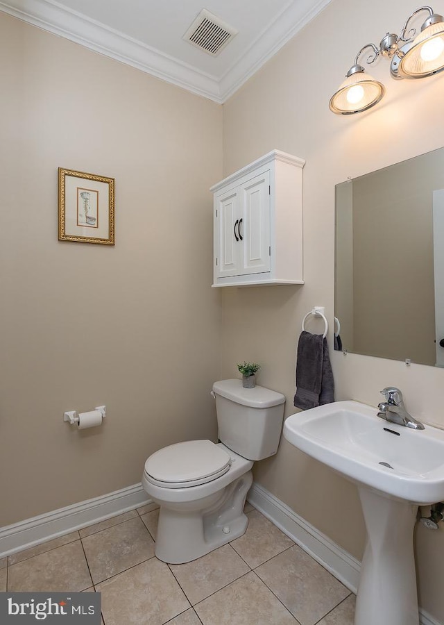 half bathroom featuring visible vents, crown molding, baseboards, toilet, and tile patterned floors