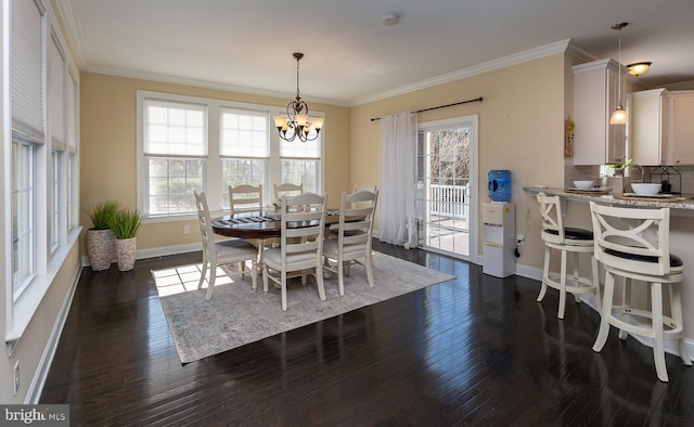 dining space featuring a notable chandelier, dark wood-type flooring, baseboards, and ornamental molding