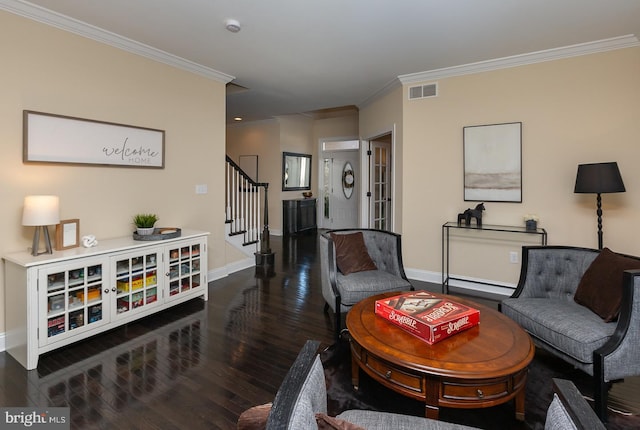 living area featuring visible vents, baseboards, stairs, ornamental molding, and wood finished floors