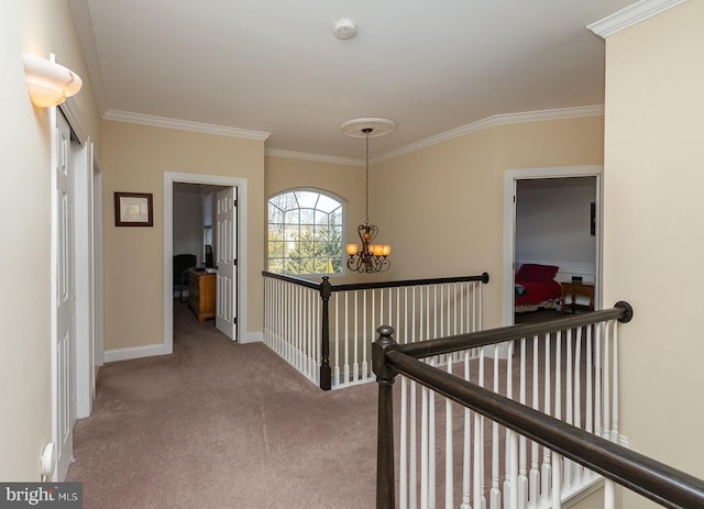 hallway featuring an upstairs landing, carpet, an inviting chandelier, and ornamental molding