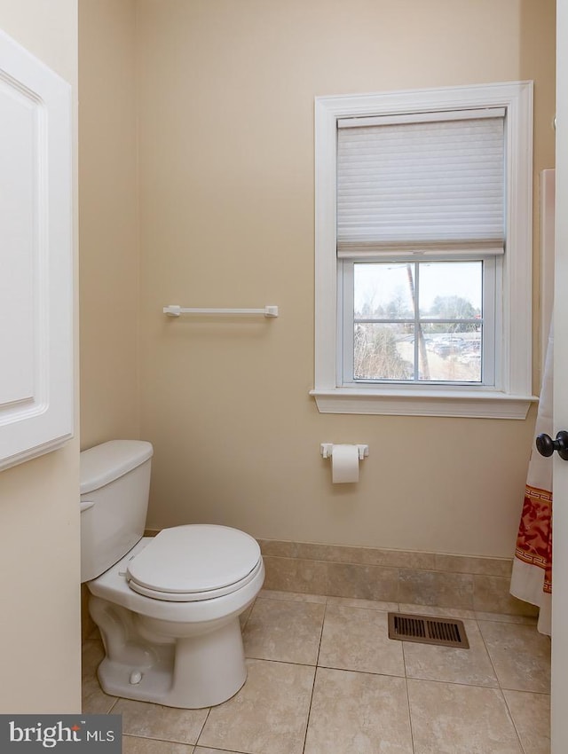 bathroom featuring tile patterned floors, visible vents, and toilet