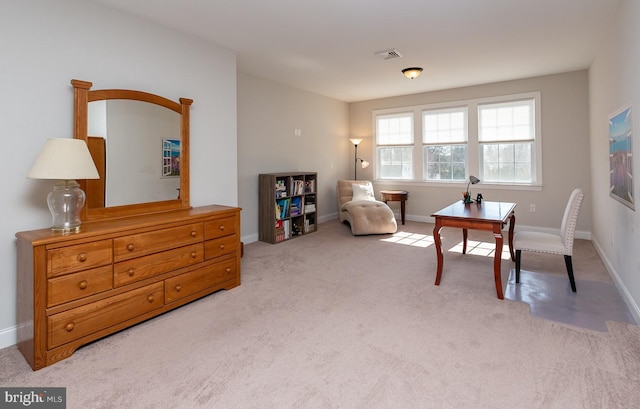 living area with baseboards, light carpet, and visible vents