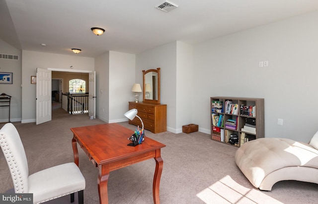 carpeted living area with visible vents and baseboards