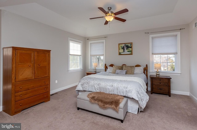 bedroom featuring light carpet, ceiling fan, and baseboards