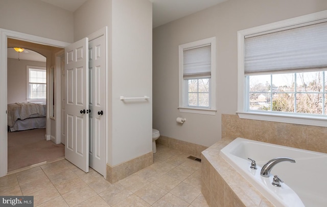 bathroom with visible vents, toilet, a garden tub, tile patterned floors, and ensuite bath