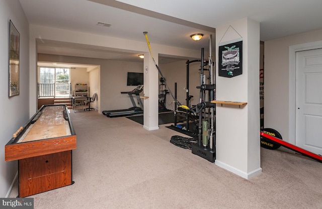 workout room featuring visible vents, baseboards, and carpet