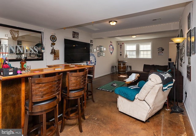 living room with visible vents, heating unit, a bar, and finished concrete floors