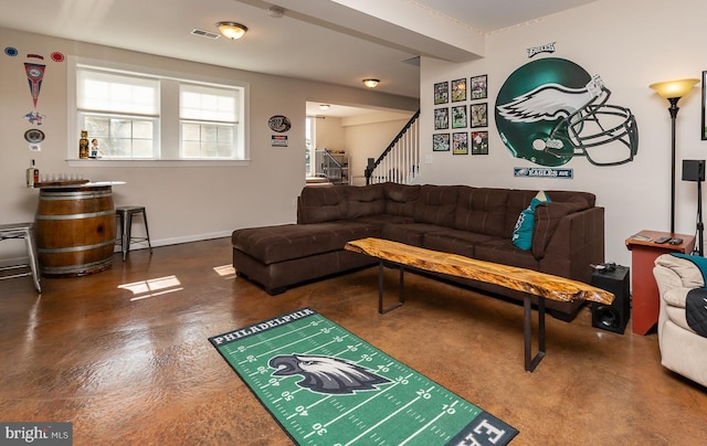 living area featuring stairway, baseboards, and visible vents