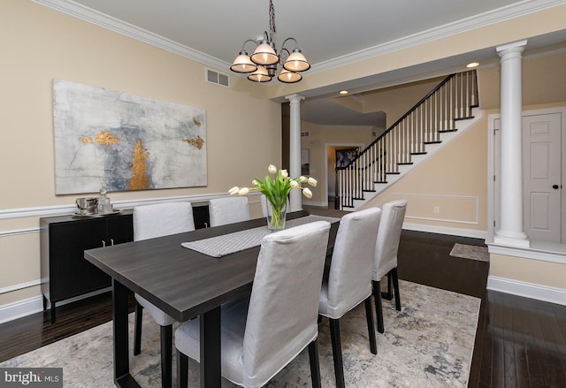 dining area with visible vents, crown molding, baseboards, hardwood / wood-style flooring, and ornate columns