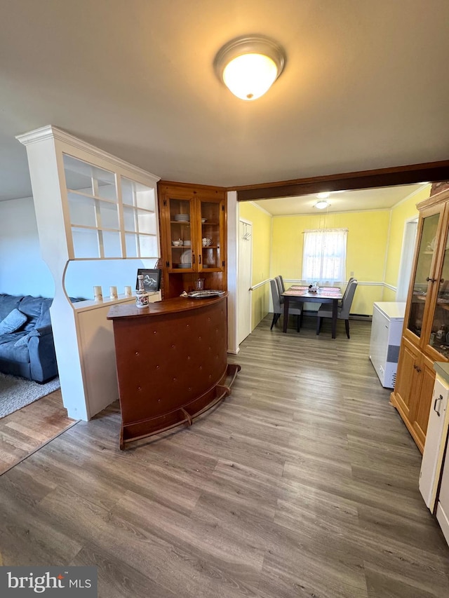 interior space with glass insert cabinets and wood finished floors