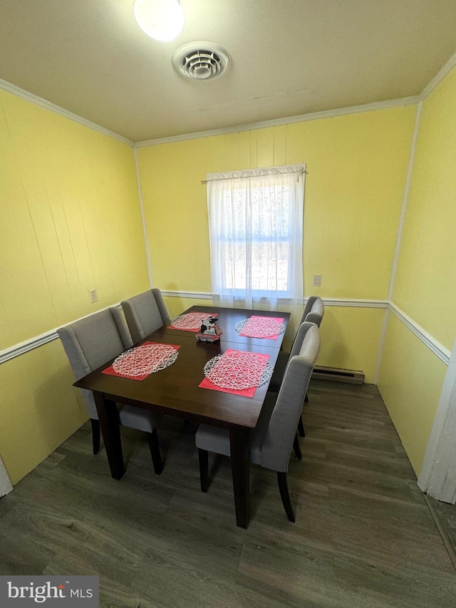 dining space featuring visible vents, wood finished floors, and ornamental molding