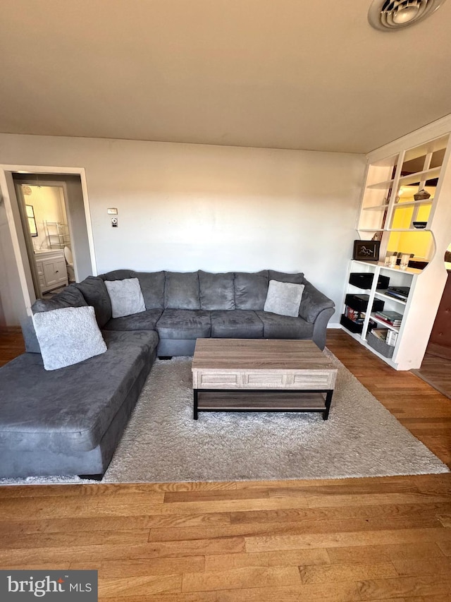 living room featuring wood finished floors and visible vents