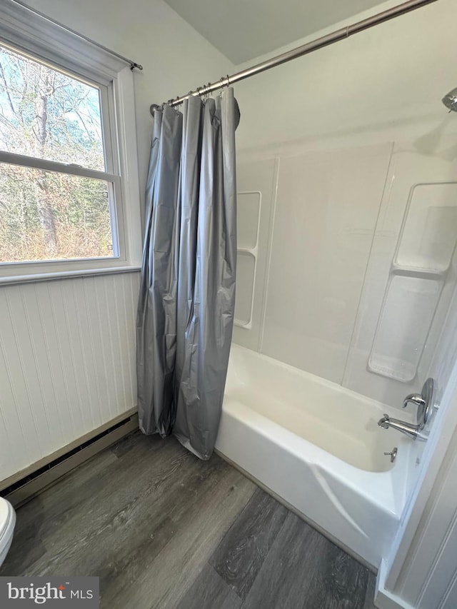 full bathroom featuring shower / tub combo, toilet, wood finished floors, and a baseboard radiator