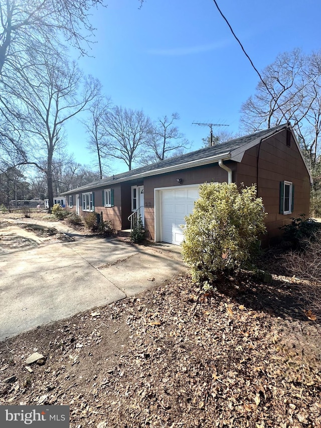 view of front of house with concrete driveway and an attached garage