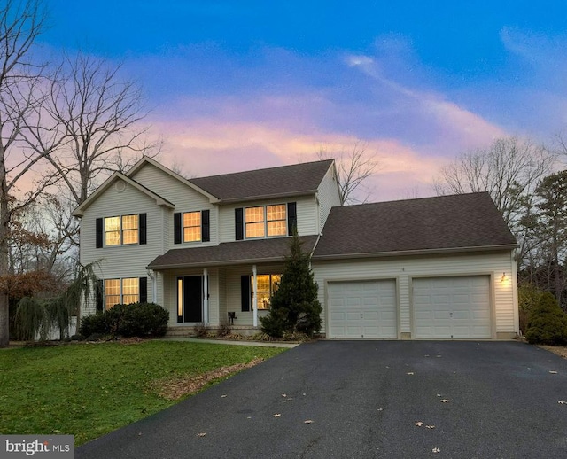 traditional home featuring aphalt driveway, a front lawn, a garage, and roof with shingles