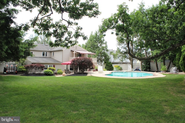 pool featuring a yard and fence