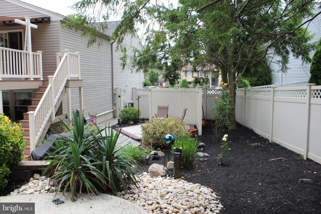 view of yard with a fenced backyard and stairs