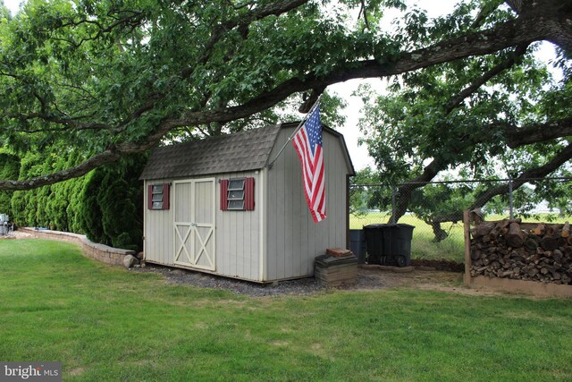 view of shed featuring fence