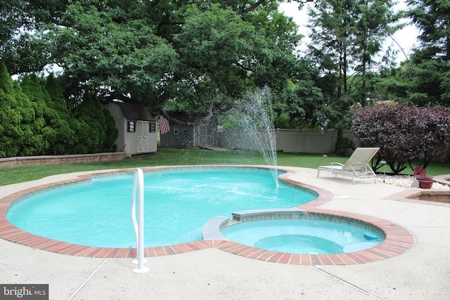 view of pool with an outbuilding, a patio, a pool with connected hot tub, fence, and a shed