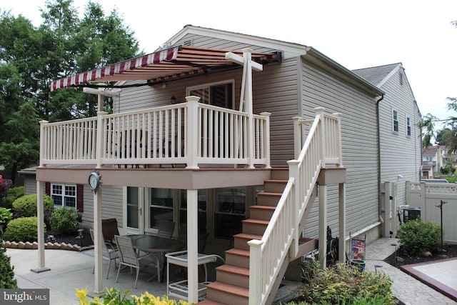 back of property featuring stairs, a patio area, and cooling unit