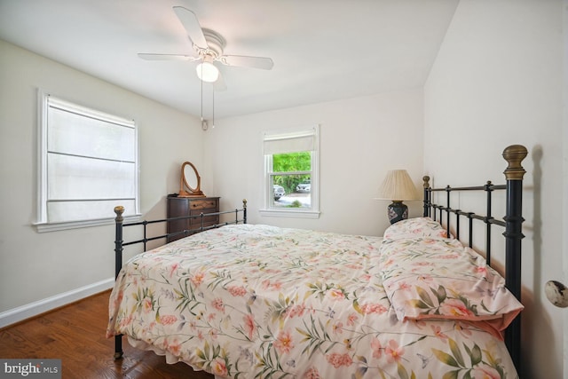 bedroom with ceiling fan, baseboards, and wood finished floors