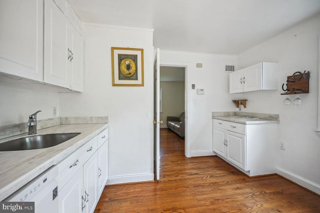 kitchen featuring visible vents, white cabinetry, dark wood-style flooring, a sink, and dishwasher