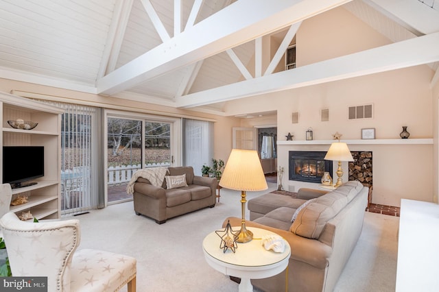 carpeted living room featuring visible vents, beamed ceiling, high vaulted ceiling, and a glass covered fireplace